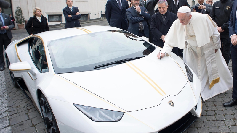 The car features gold stripes and gold-rimmed wing mirrors