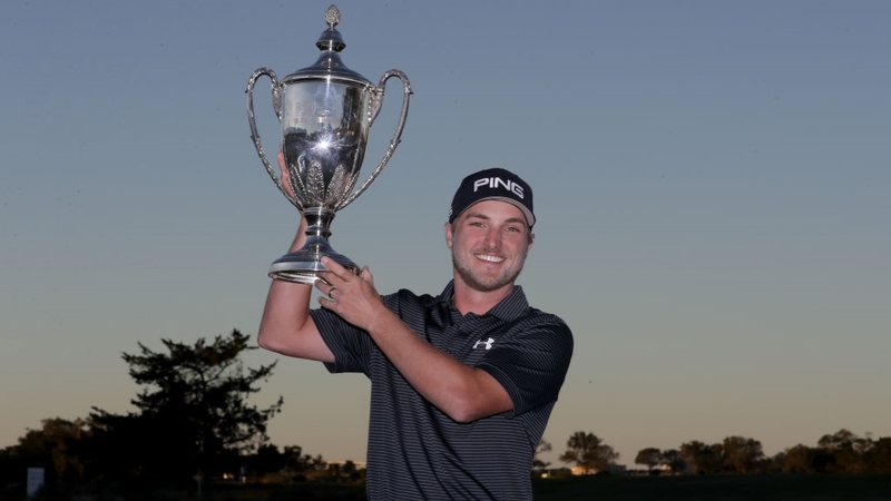 Austin Cook celebrates with the trophy