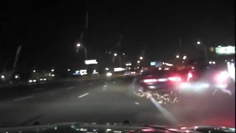 The car crashed into the side of the patrol car, narrowly missing a group of people