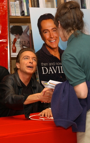 David Cassidy greets a fan during an in-store appearance to promote his new release 'Then and Now' at Virgin Megastore May 15, 2002