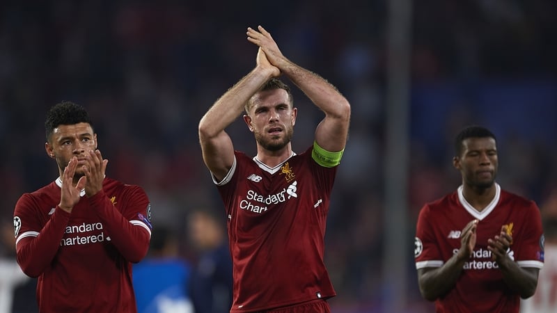 Jordan Henderson (C), Alex Oxlade-Chamberlain (L) and Georginio Wijnaldum applaud the Liverpool fans