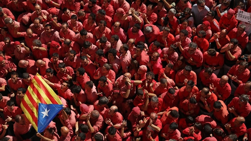 Members of the pink human tower team hold up a Catalan independence flag at St. Ursula festival in Valls, Spain. Photo: Sean Gallup/Getty Images