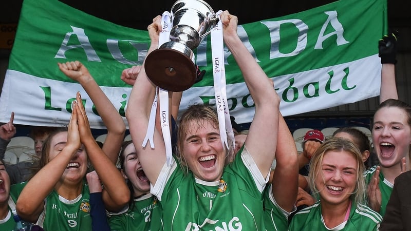 Aghada captain Emma Farmer lifts the cup