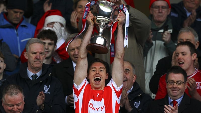 Cuala captain Paul Schutte raises the trophy