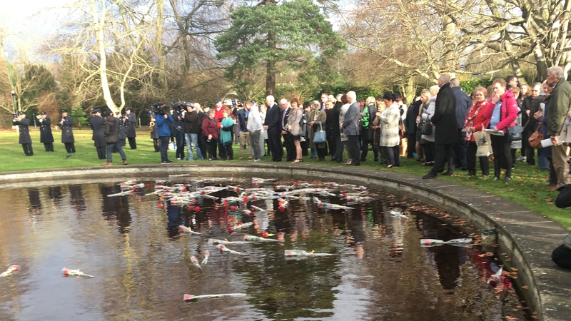 Families laid remembrance roses after the indoor ceremony