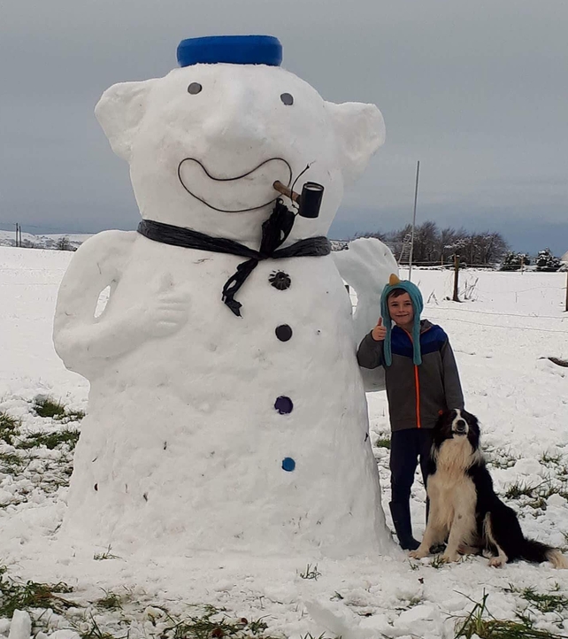 James Dunne, aged nine, with his dog Bailey enjoying the snow in Ballyfin, Co Laois (Pic: Rebecca Conroy)