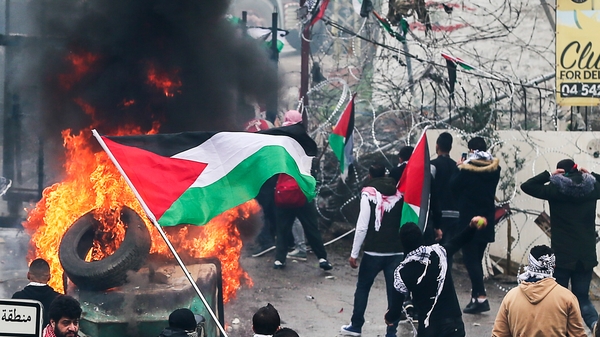 Protesters set fires in the street near the US embassy in Beirut, Lebanon