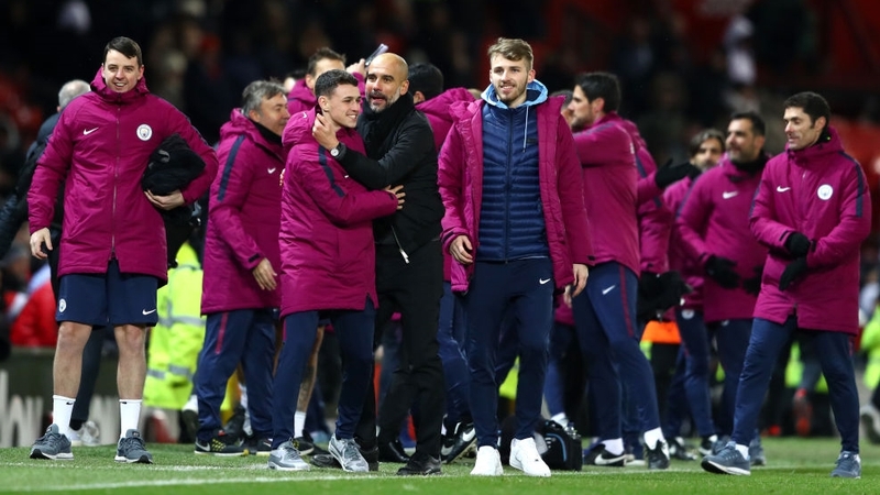 Pep Guardiola celebrates with his players after beating Manchester United