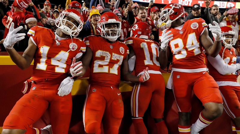 Running back Kareem Hunt (No 27) of the Kansas City Chiefs celebrates with teammates in the endzone after scoring a touchdown