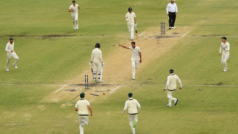Mitchell Starc of Australia celebrates getting the wicket of James Vince