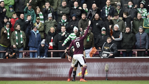 Kyle Lafferty celebrates in front of the Celtic fans after scoring Hearts' second