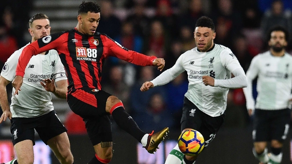 Joshua King (C) holds off Liverpool's Jordan Henderson (L) and Alex Oxlade-Chamberlain
