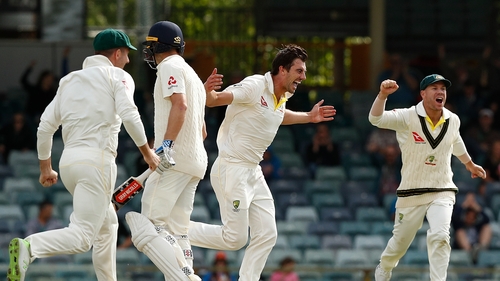 Pat Cummins of Australia celebrates the wicket of Chris Woakes