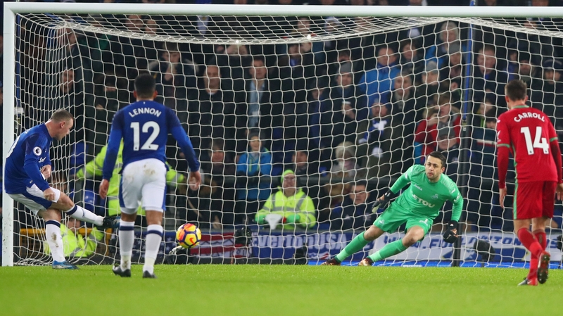 Lukasz Fabianski of Swansea City saves a penalty from Wayne Rooney