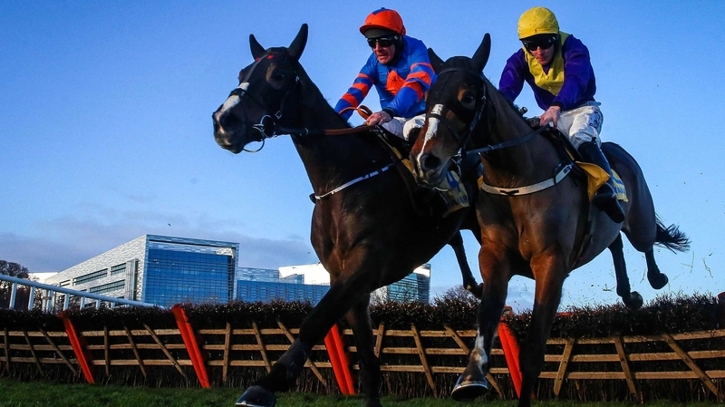 Davy Russell onboard Mick Jazz (l) clears the last on his way to winning ahead of David Mullins onboard Cilaos Emery