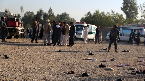 Security officials observe the scene following the blast