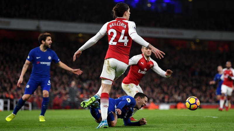 Eden Hazard goes down under a challenge from Hector Bellerin