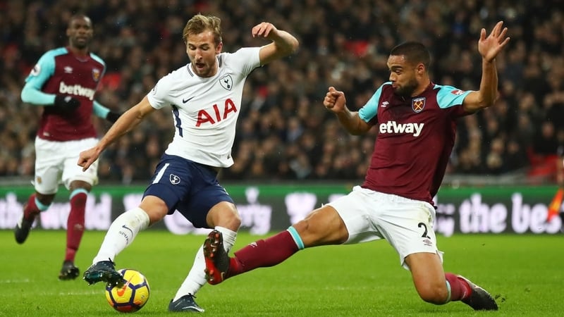 Harry Kane is challenged by West Ham's Winston Reid