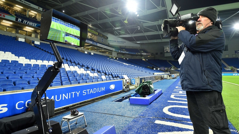 A cameraman films the the Video Assistant Referee system at Brighton's stadium