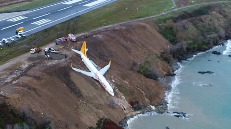 Dramatic images show the plane lying on the cliff-side, its nose just metres from the waters of the Black Sea