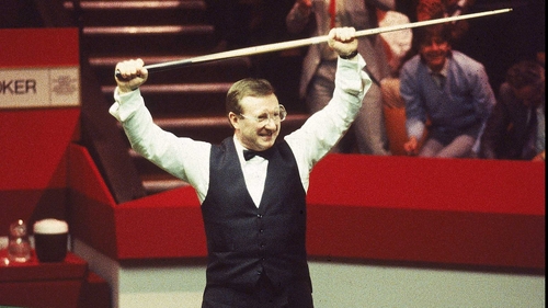 Taylor raises his cue after sinking that black ball