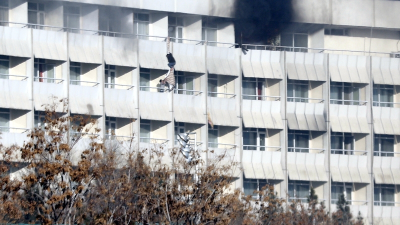 People use sheets to climb down floors at the Intercontinental Hotel during the attack