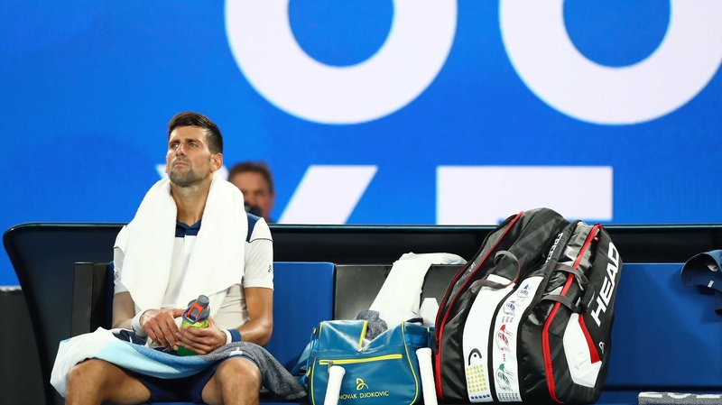 Novak Djokovic of Serbia struggles between games due to his injured elbow