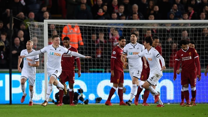 Alfie Mawson celebrates after scoring the only goal against Liverpool at the Liberty Stadium on Monday night