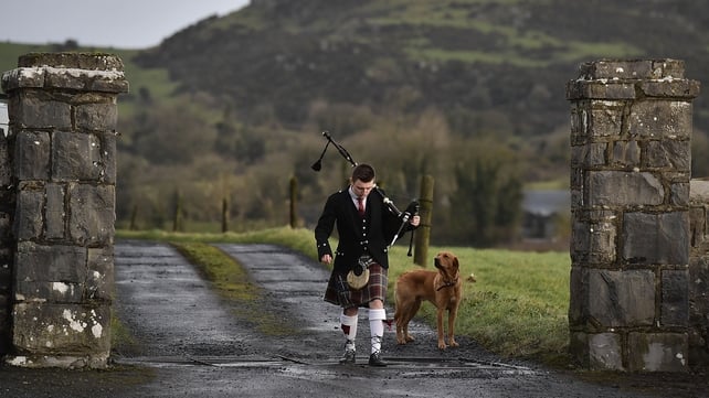 A young piper makes his way into St Ailbe's parish church in Ballybricken, Co Limerick