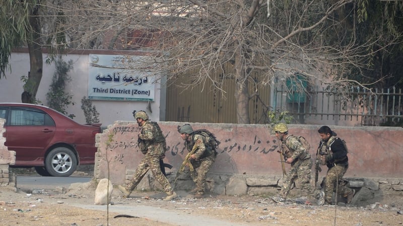 Afghan army soldiers take positions near the building