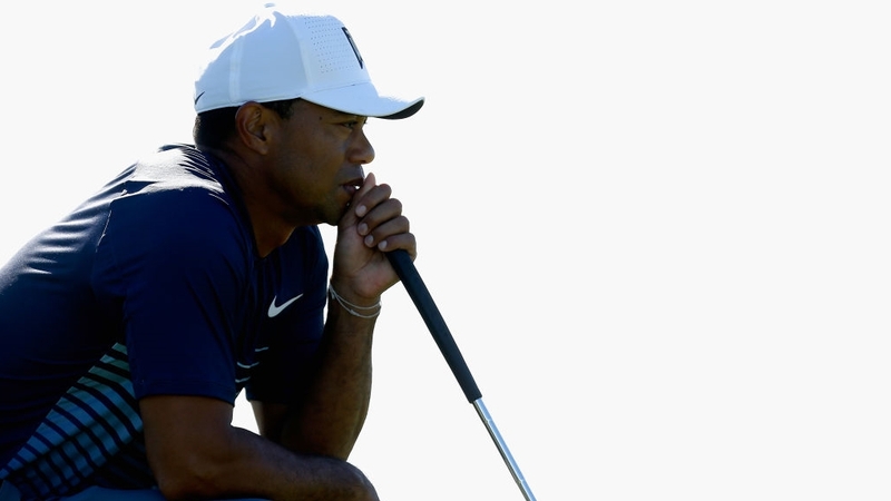Tiger Woods looks over a putt on the 13th green