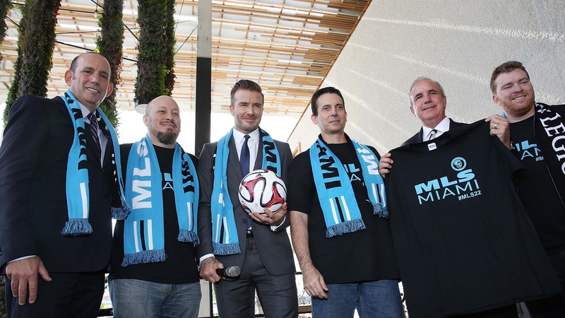 David Beckham (C) at a press conference to announce plans to launch an MLS franchise in Miami