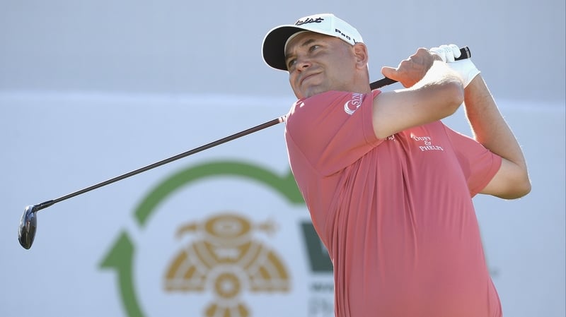 Haas watches his tee shot on the 17th