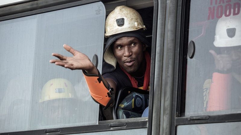 A bus transports some of the miners who were trapped in the Beatrix mine since Wednesday