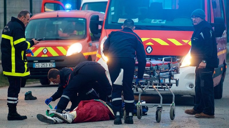 A man receives medical attention following clashes near the ferry port in Calais