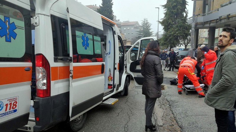 Paramedics treat an injured person at the scene in Macerata