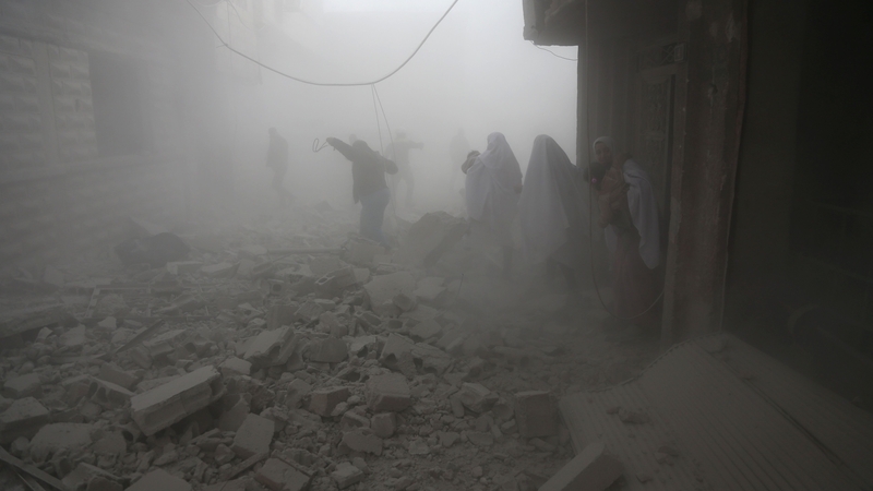 Syrians flee their homes following an airstrike in the rebel-held town of Arbin, in the eastern Ghouta region