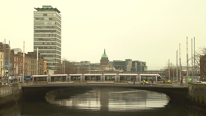 A tram crossing the Rosie Hackett Bridge on the Luas Cross City line