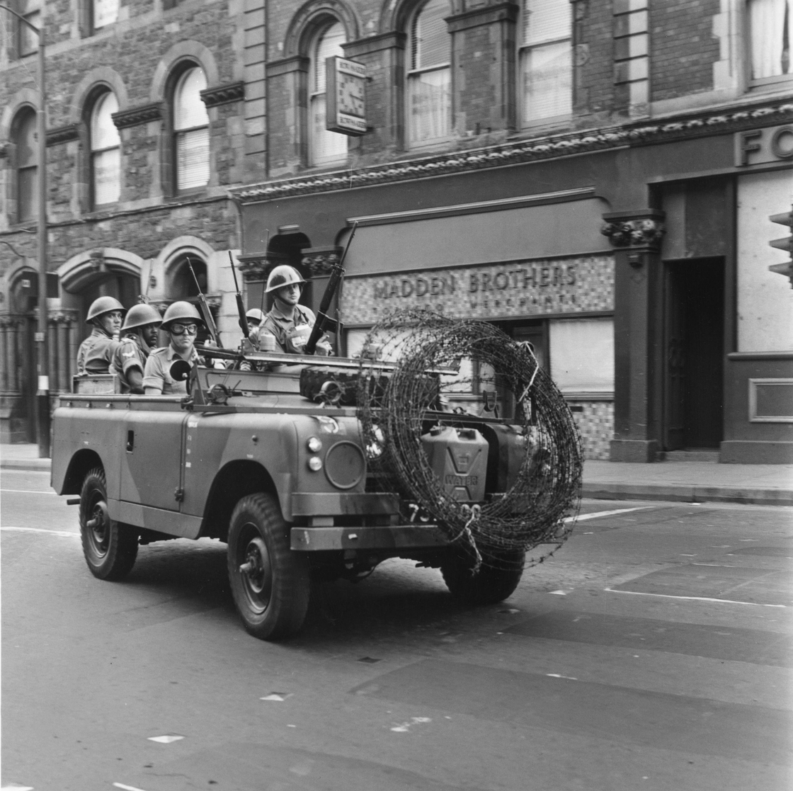 Armed British soldiers driving through Derry City on a mobile patrol, 1969