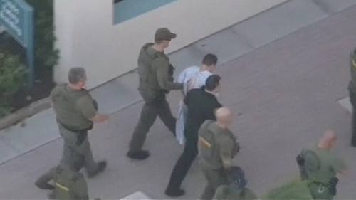 Police surround Nikolas Cruz who is suspected of carrying out the shooting