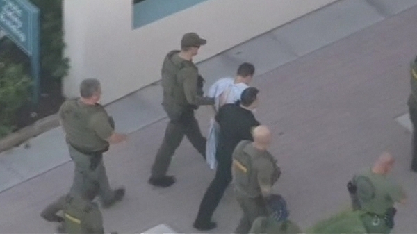 Police surround Nikolas Cruz who is suspected of carrying out the shooting