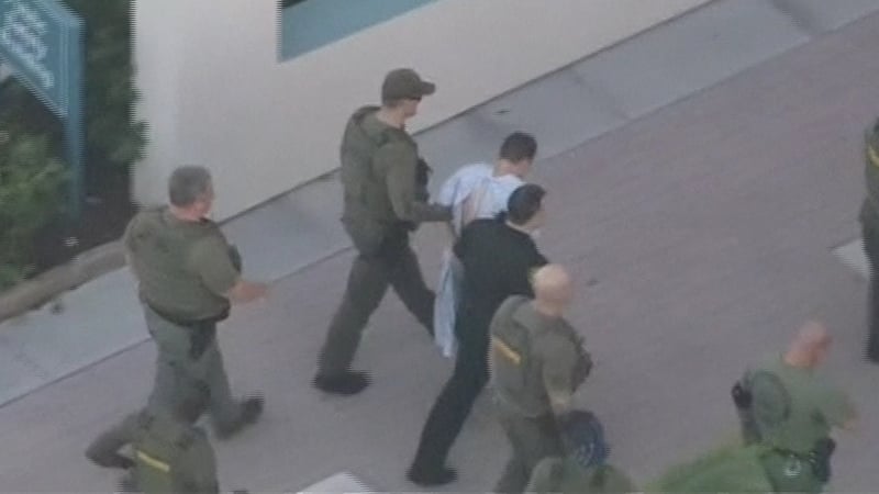 Police surround Nikolas Cruz who is suspected of carrying out the shooting