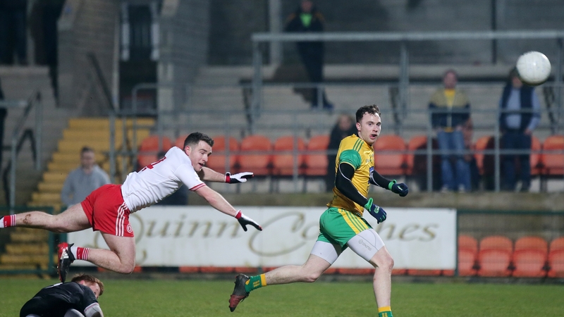 Donegal's Martin McElhinney chips Tyrone goalkeeper Mickey O'Neill to score a goal