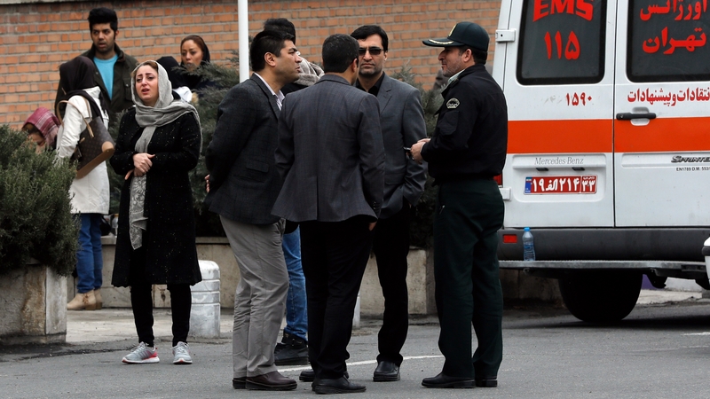 Families of those on board the plane gather outside a mosque in Tehran