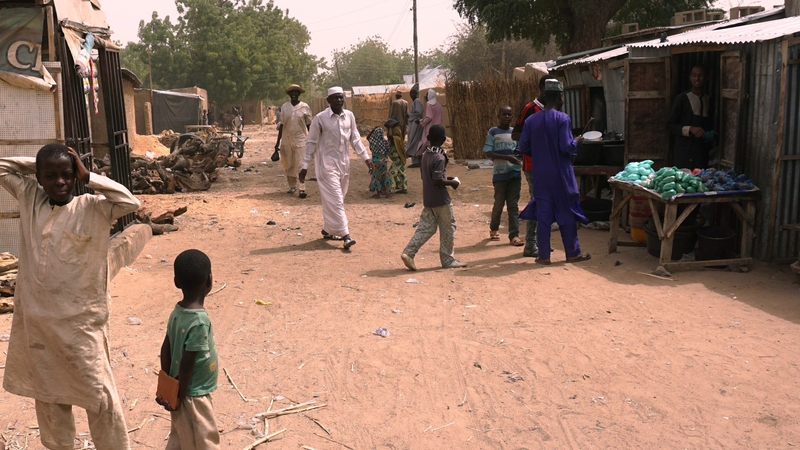 Residents walk along a street in Dapchi, Nigeria