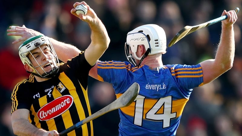Kilkenny's Paddy Deegan and Michael Breen of Tipperary compete for the ball