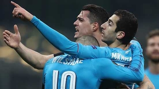 Henrikh Mkhitaryan is mobbed after his opener against AC Milan
