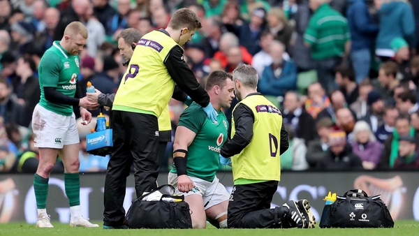Cian Healy receives medical treatment on the pitch against Scotland
