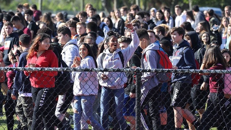 Students from Marjory Stoneman Douglas High School gather to honour their 17 classmates who were killed during a mass shooting at the school