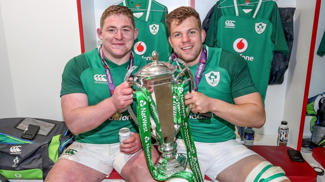 Tadhg Furlong and Jordi Murphy happily pose with the trophy in the changing room